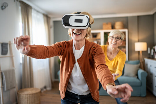 Mature woman wearing vr headset playing engaging game