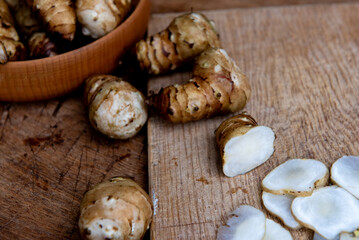 Fresh Sliced Jerusalem Artichokes on Wooden Cutting Board