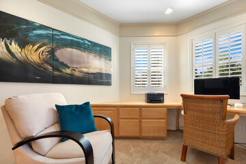 A comfortable home office featuring a chair, a desk, and a computer