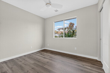 Welllit Room With Quiet Hardwood, Sunny Space Showcasing Polished Wooden Floors And Peaceful Nook