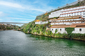 Fototapeta premium Colorful buildings at Ribeira Quay, iconic postcard location on the banks of the Douro River, famous for its medieval alleys and lively nightlife, UNESCO World Heritage Site. Porto, 2023