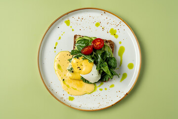 Enjoy a delightful brunch with poached eggs nestled on fresh spinach, drizzled with rich hollandaise sauce, and garnished with cherry tomatoes on artisan toast