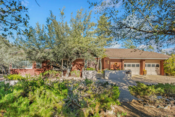 Fototapeta premium Natural Oaks Landscape, Beautiful Driveway Shaded By Mature Oaks Leading To Peaceful Ranch Residence
