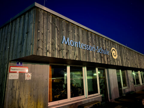 Montessori school building exterior at night