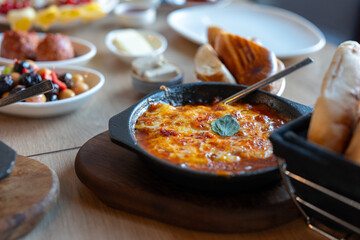 Delicious Shakshuka With Tomato Sauce And Melted Cheese Served In Cast Iron Pan With Bread And...