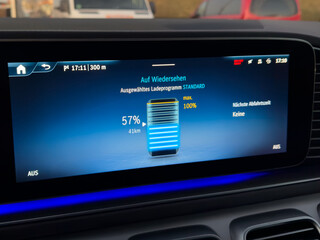 Car screen displaying electric vehicle battery charging status