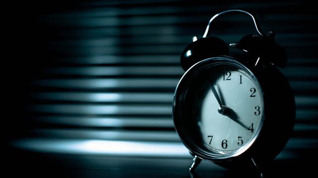 Moody close-up of an alarm clock in soft light for time management and productivity themes
