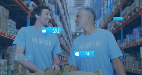 Talking two men in light-blue VOLUNTEER shirts holding brown-bags in warehouse aisle, racks, icons