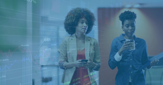 Walking two coworkers in office hall in blazer, denim, holding phone, cup, folder, showing charts
