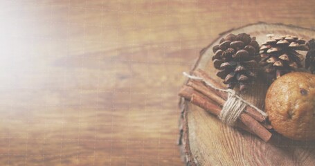Showing rustic cluster on wood slab at table, with pinecones, tied cinnamon sticks, copy space