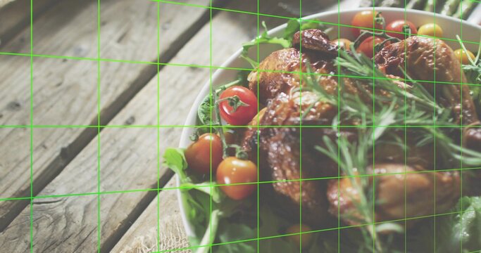 Fototapeta Resting roasted chicken sitting on white bowl on wooden table, with salad, rosemary and green grid