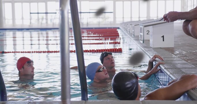 Gathering swimmers in swimwear with caps and goggles, practicing at pool edge, blocks 1-2 visible