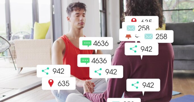 Holding hands two adults meditating on yoga mats in sunlit living room with notification graphics