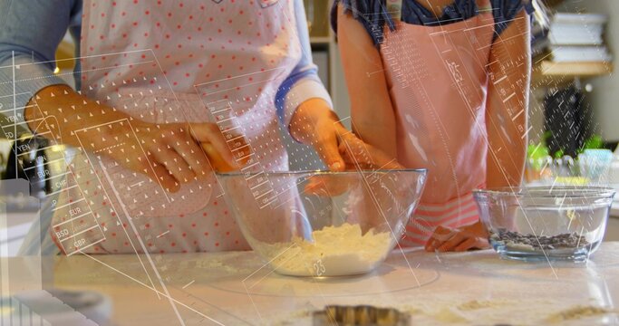 Mixing adult and child in aprons stirring dough on kitchen counter, with glass bowl, cookie cutter - Powered by Adobe