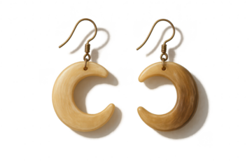 Pair of elegant bone or horn crescent moon earrings isolated on transparent background