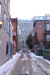 A view of an old street in the old Quebec city. Quebec destination and winter tourism. Old architecture in Quebec city in Canada and historic buildings.	
