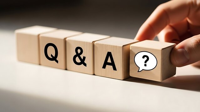 Wooden blocks spelling out QA with a question mark symbol sitting on a white surface representing questions and answers in a bright, clean studio shot.