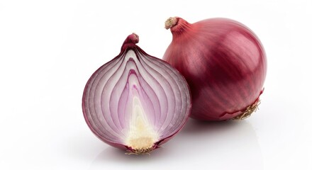 Two red onions, one whole and the other cut in half, on a white surface
