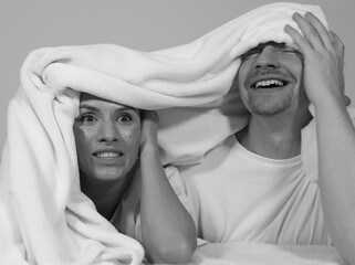 Beautiful happy loving young smiling couple relaxing in bed