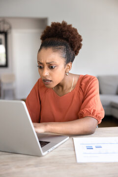 Shocked worried young African project manager working from home