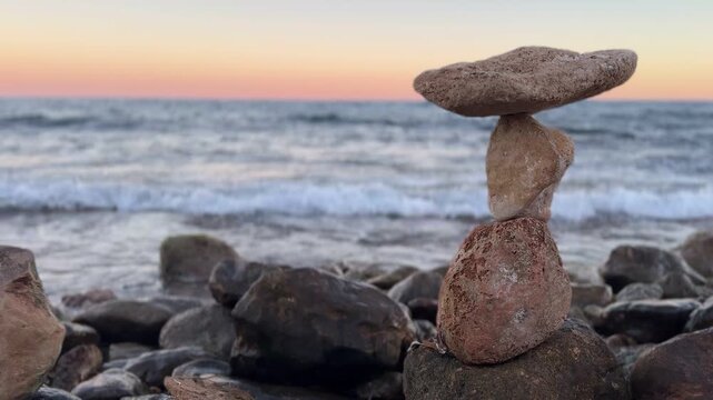 Stone balancing tower photographed in daylight with clear blue sky, symbolizing stability, strength, focus and natural harmony. Perfect for business concepts, coaching, leadership, wellness