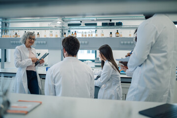 Education in laboratory with science students and professor