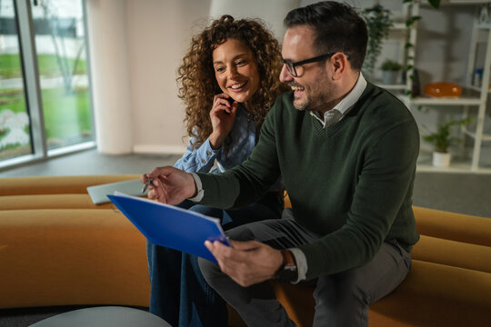 Business colleagues discussing work project using digital tablet in office