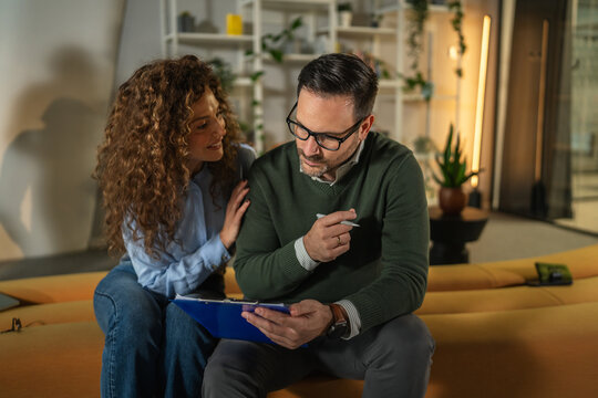 Couple signing document with financial adviser for future planning - Powered by Adobe