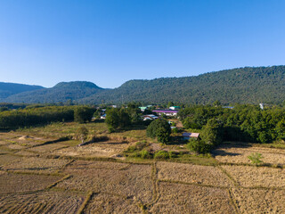 Peaceful rural village beside the mountains in Dong Luang, Mukdahan, capturing authentic travel scenery and natural highland life.