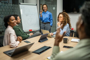 Business colleagues discussing data during corporate meeting in office