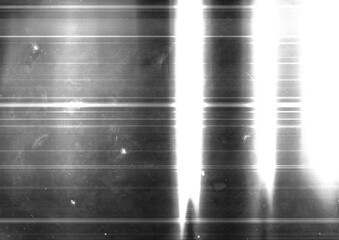 Black and white abstract distressed film texture background. Grunge light streaks backdrop. For vintage film grain effect graphic element.