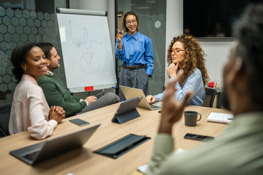 Business colleagues discussing data during corporate meeting in office