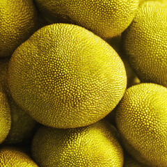 Close-up stack of jackfruits with rugged patterns and natural imperfections. Ideal for organic produce ads, exotic food blogs, and harvest-themed photography.