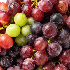 A fresh stack of ripe grapes piled together, showcasing glossy skins, rich color, and natural bloom. Perfect for fruit backgrounds, healthy food concepts, and clean produce photography.