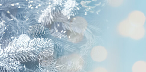 Christmas greeting card with fir tree branches and bokeh lights. Banner design