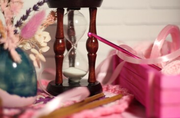 Composition with hourglass clew ball wool yarn pink objects cozy photo 