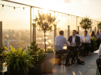Blurred people relaxing at a rooftop bar with a city view at sunset