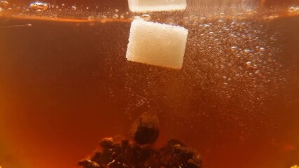Sugar cubes falling into a dark, bubbly beverage, creating a dynamic and refreshing scene with dissolving particles. - Powered by Adobe