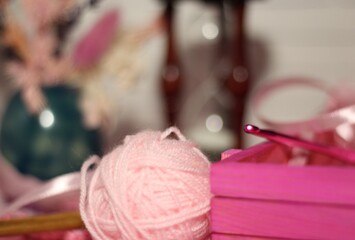 Composition with hourglass clew ball wool yarn pink objects cozy photo 