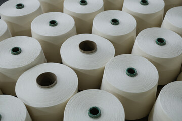 A close-up of a spool of yarn inside the factory