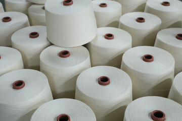 A close-up of a spool of yarn inside the factory