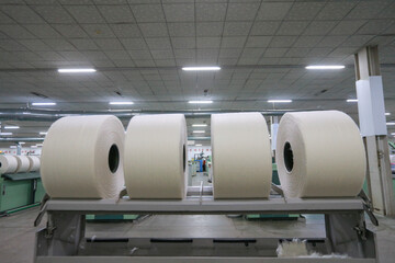 A close-up of a spool of yarn inside the factory