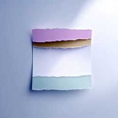 Close-up of a composition featuring torn paper layers in various colors, arranged against a blue background, creating a minimalist and artistic aesthetic.