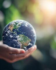 a hand holding the planet earth on a blurred green background, a concept for environmental protection and world environment day
