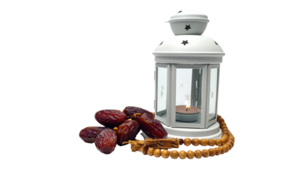 Arrangement of dates, prayer beads and white metal lantern on black