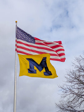 Ann Arbor, MI - November 28, 2025: University of Michigan and American flags in the wind