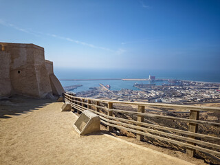 Breathtaking high-angle panoramic view of Agadir city, port, and coastline from the historic Kasbah Agadir Oufelah fort in Morocco under a bright blue sky