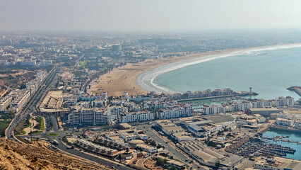 High Angle Panoramic View of Agadir City, Wide Sandy Beach, Port, and Modern Buildings from the Kasbah background Fortress Hill