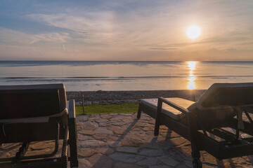 Beach Chair Facing Sunrise Over the Sea Peaceful Morning Coastal View