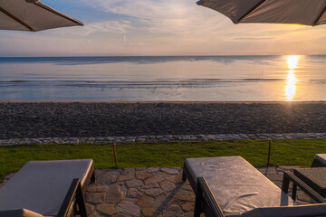 Beach Chair Facing Sunrise Over the Sea Peaceful Morning Coastal View